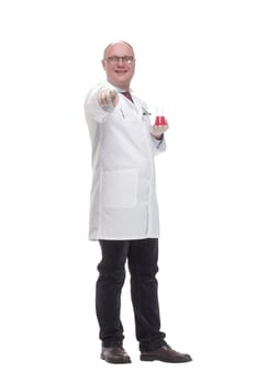 in full growth. qualified mature doctor with laboratory flask. isolated on a white background.