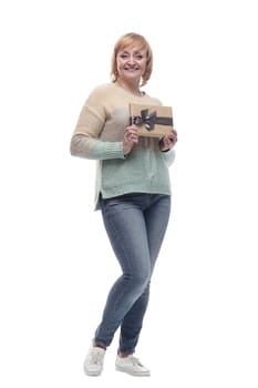 in full growth. attractive casual woman with a gift box. isolated on a white background.