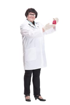 in full growth. senior female doctor with a laboratory flask . isolated on a white background.