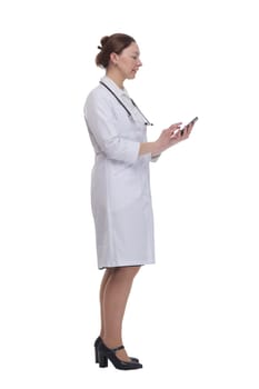 in full growth.female doctor with a smartphone. isolated on a white background.