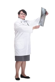 in full growth. older woman is a medic with an x-ray in her hands. isolated on a white background.