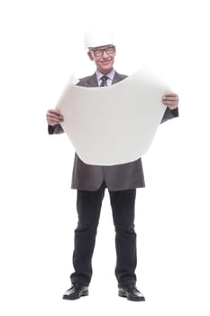 in full growth. business man in a protective helmet with drawings. isolated on a white background.