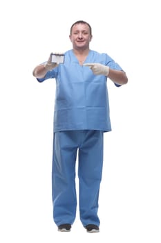 in full growth. doctor showing his business card. isolated on a white background.