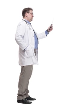 in full growth. serious doctor looking at an x-ray.isolated on a white background.