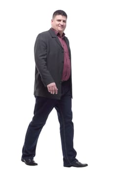 Mature man in business suit striding forward. isolated on a white background.