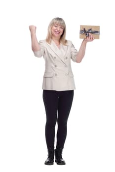 full-length. a friendly adult woman with a gift box looking at you . isolated on a white background.