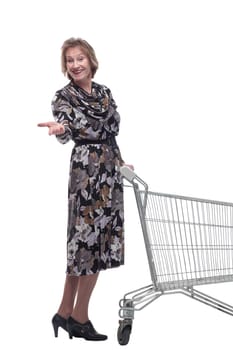 Profile of mature woman, pensioner shopping with shopping trolley looking at camera