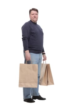 in full growth. Mature man in jeans striding forward.isolated on a white background.