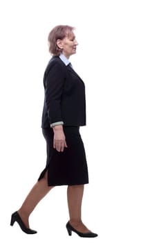in full growth. Mature business woman stepping forward. isolated on a white background