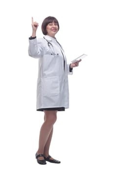 in full growth. female doctor using a digital tablet . isolated on a white background.