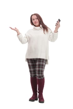 in full growth. attractive casual woman with a smartphone .isolated on a white background.