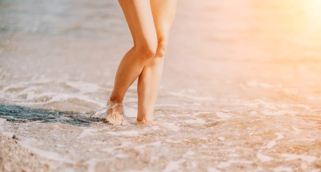 Barefoot woman standing in sea, summer vacation on beach resort. Naked female legs in transparent calm water