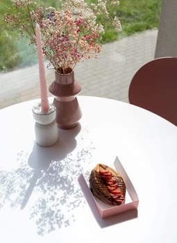 Genital Vagina, Vulva Shaped Waffle With Berries, Dark Chocolate On White Table With Flowers And Candle. Festival Pride Food, Cookie. Vertical Plane. High quality photo