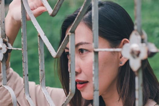 Women look out And standing holding steel mesh