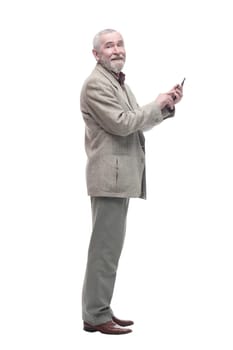 in full growth. elderly businessman with a smartphone. isolated on a white background.