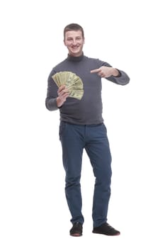 in full growth. casual young man with dollar bills. isolated on a white background.