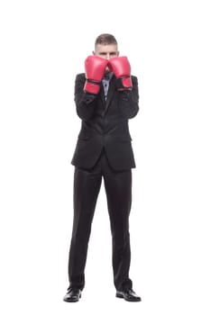 in full growth. young businessman in Boxing gloves. isolated on a white background.