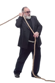 side view. Mature businessman in glasses pulls the rope . isolated on a white background.