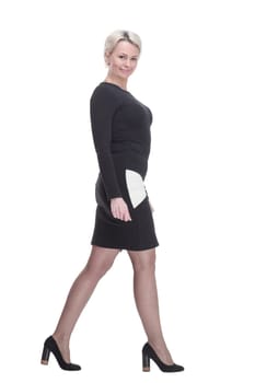 side view.confident business woman striding forward. isolated on a white background.