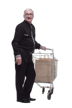 in full growth. happy old man with a shopping cart . isolated on a white background.