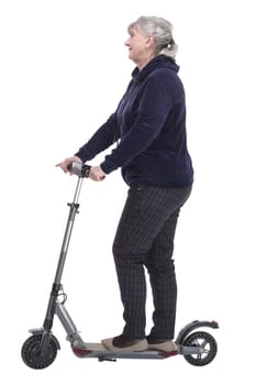 side view. elderly woman with an electric scooter looking at a white screen. isolated on a white background.