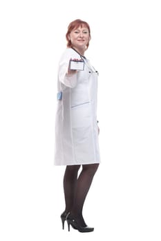 in full growth. competent female doctor showing her business card . isolated on a white background.