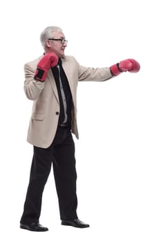 in full growth. Mature, intelligent man in Boxing gloves. isolated on a white background.