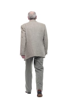 in full growth. confident old man striding forward . isolated on a white background.