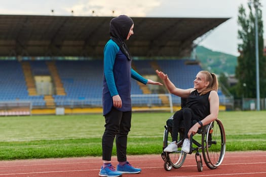 A Muslim woman wearing a burqa supports her friend with disability in a wheelchair as they train together on a marathon course