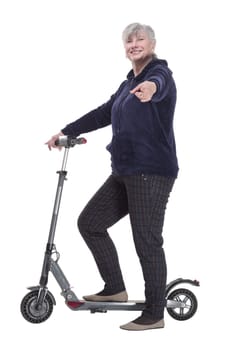 side view. smiling elderly woman with an electric scooter looking at you . isolated on a white background.