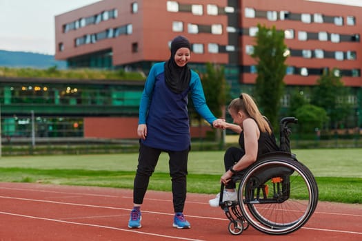 A Muslim woman wearing a burqa supports her friend with disability in a wheelchair as they train together on a marathon course