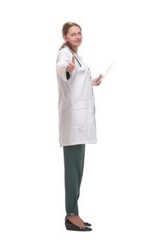 Side view of happy female doctor writing patient chart on digital tablet over white background