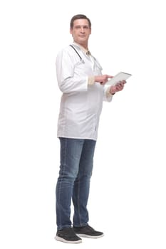 Side view of confident doctor wearing uniform and glasses using digital tablet. Isolated on white background