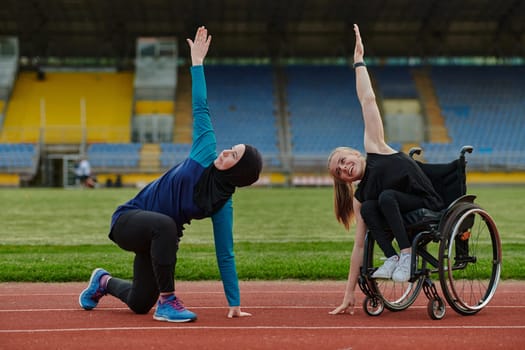 Two strong and inspiring women, one a Muslim wearing a burka and the other in a wheelchair stretching and preparing their bodies for a marathon race on the track.