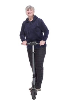 in full growth. happy elderly woman moving around on an electric scooter . isolated on a white background.