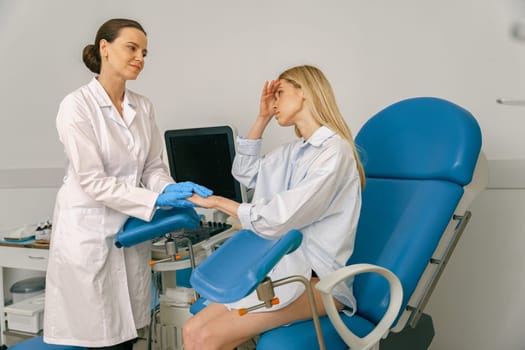 Woman is talking and shaking hands with a gynecologist in woman consultation . High quality photo