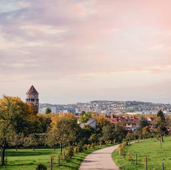 Germany, Stuttgart panorama view. Beautiful houses in autumn, Sky and nature landscape. Vineyards in Stuttgart - colorful wine growing region in the south of Germany with view over Neckar Valley. Germany, Stuttgart city panorama view above vineyards, industry, houses, streets, stadium and highway at sunset in warm orange light.