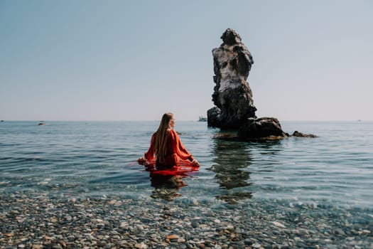 Woman travel sea. Happy tourist taking picture outdoors for memories. Woman traveler looks at the edge of the cliff on the sea bay of mountains, sharing travel adventure journey.