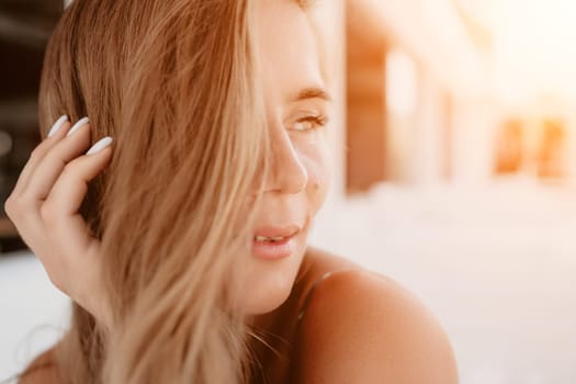 Happy woman portrait in cafe. Boho chic fashion style. Outdoor photo of young happy woman with long hair, sunny weather outdoors sitting in modern cafe