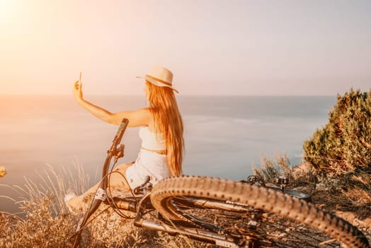 Woman travel sea. Young Happy woman in a long red dress posing on a beach near the sea on background of volcanic rocks, like in Iceland, sharing travel adventure journey