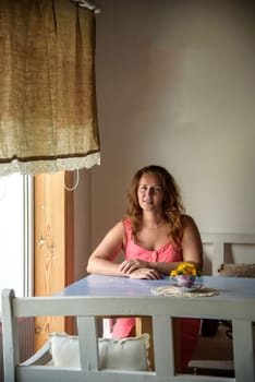 Enthusiastic Woman in trendy summer outfit chilling in cozy cafe, looking around , happy emotions. Traveling woman.