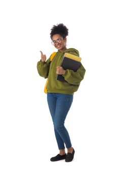 Full length portrait of pretty smiling african american girl university student with thumb up isolated on white background