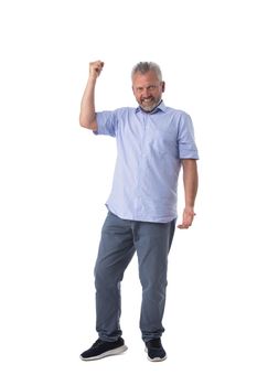 Senior man cheering his success raising fist in the air as he smiles with satisfaction isolated on white background