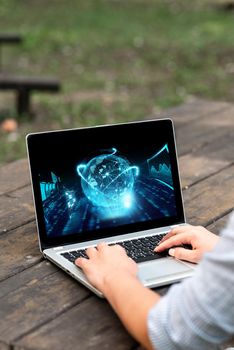 Laptop Placed Resting On Table Working In The Park Doing Remote Jobs.