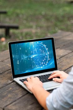 Laptop Placed Resting On Table Working In The Park Doing Remote Jobs.