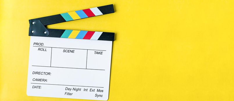 Filmmaker profession. Clapperboard on yellow background