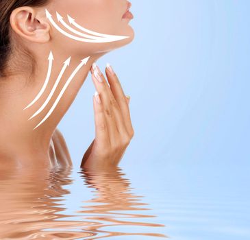 Pretty woman touching her neck, light blue background. Anti-aging concept. Skin care
