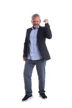 Senior businessman cheering his success raising fist in the air as he smiles with satisfaction isolated on white background