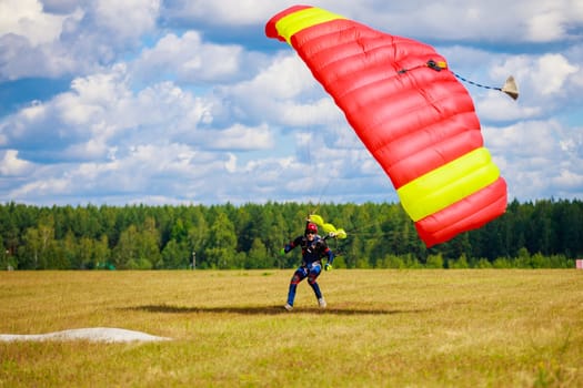 Landing skydivers-athletes with a parachute on the ground. High quality photo. Kirzhach Russia July 22, 2023