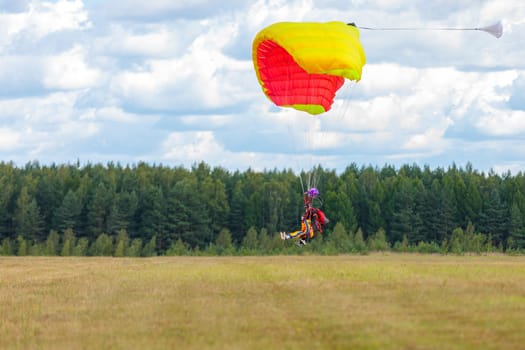 Landing skydivers-athletes with a parachute on the ground. Kirzhach Russia July 22, 2023